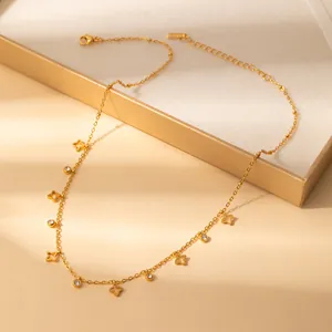 Detail of gold petal necklace featuring hollow floral charms and clear zircon stones