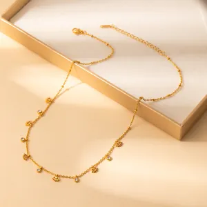 Detailed close-up of golden petal pendant necklace with lobster clasp and extension chain