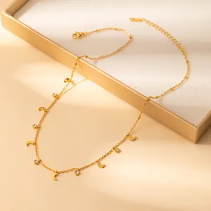 Detail of gold moon pendant necklace with cubic zirconia displayed in a jewelry box