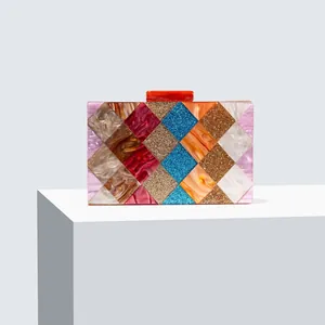 Detail of colorful geometric acrylic clutch with marble textures and secure top clasp