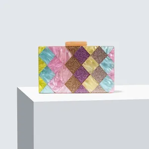 Detail view of multicolored acrylic evening clutch with sequin diamond patterns and marble clasp