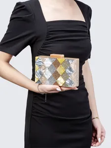 Detail of acrylic evening clutch with marble patchwork design and metallic clasp closure