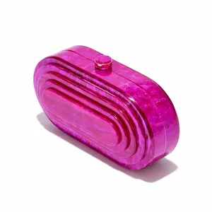 Detail of fuchsia marble texture acrylic evening bag with concentric embossed design