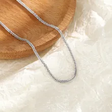 Close-up of elegant silver double-layer chain necklace showing refined metallic texture