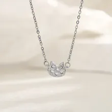 Detail of a cat-shaped pendant with pavé cubic zirconia on a delicate silver chain