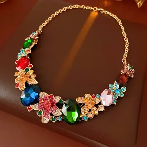 Macro shot of colorful floral gemstone necklace with emerald and ruby multi-cut stones