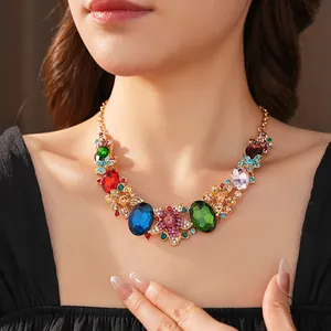 Close-up of vibrant crystal flower necklace with emerald and sapphire accents