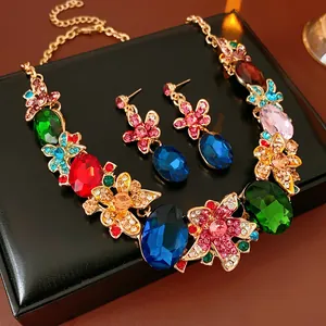 Detail shot of luxury floral necklace set with colorful gemstones on black leather base