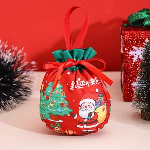 Detail of red Christmas drawstring gift bag with Santa Claus cartoon and ribbon handle