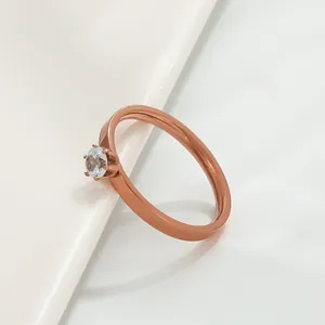 Macro shot of rose gold ring featuring a six-prong set round cubic zirconia solitaire