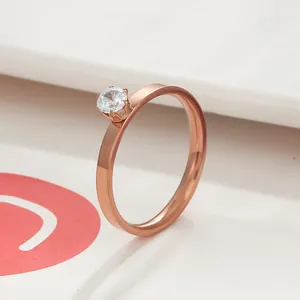 Close-up of rose gold crown ring with a six-prong solitaire cubic zirconia setting