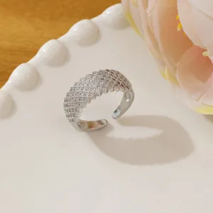 Close-up of silver adjustable ring with multi-row micro-pave crystals on white tray