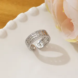 Macro detail of silver honeycomb ring with micro-pave zircons and open design