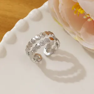 Close-up of a silver honeycomb layered ring featuring micro-pave crystals in detail