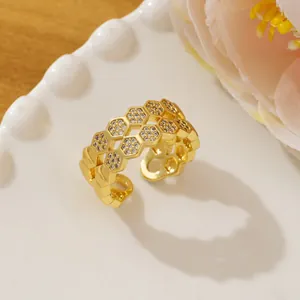 Detail of gold honeycomb ring with micro-pave diamonds and adjustable open band