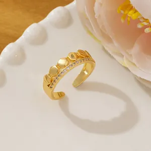 Detailed view of a gold hexagonal honeycomb ring with micro-pave diamonds on a ceramic plate