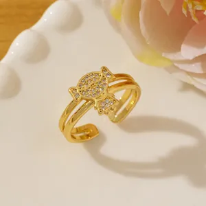 Close-up of gold double-layer open ring with sparkling pavé micro-inlaid girl motif
