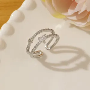 Macro detail of silver double-layered open ring with heart stone and zircon pavé