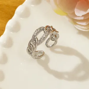 Close-up of silver adjustable chain ring with micro-paved rhinestones on elegant ceramic