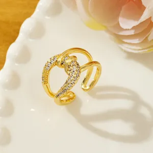 Close-up of gold twist ring featuring pavé-set sparkling zircons and open design