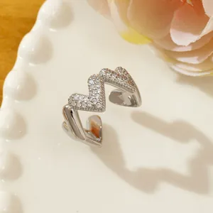 Close-up of adjustable silver ring with pave zircon stones in a wave pattern