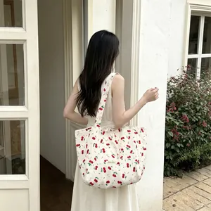 Outdoor shot of cherry floral canvas tote bag with ribbon straps and large capacity
