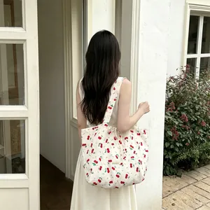 Detail of cherry floral print canvas tote bag with a minimalist Sezakka woven label