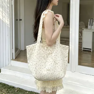 Floral chiffon tote bag with bow detail and large capacity shown on a female model