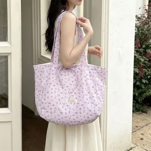 Detailed close-up of light purple floral tote bag featuring Sozakka brand tag and drawstrings