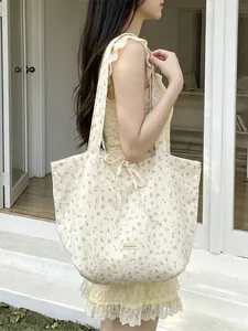 Floral print chiffon tote bag with bow shoulder strap shown on model outdoors