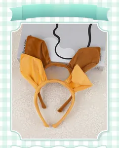 Close-up of plush brown and yellow kangaroo ear headbands on decorative lace background