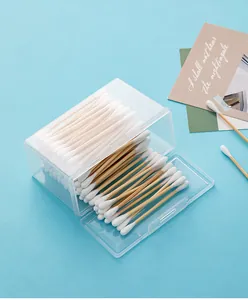 Close-up of a transparent storage box with double-headed wooden cotton swabs inside