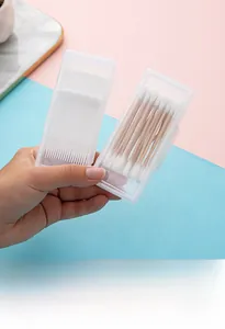 Detail of portable storage boxes holding dental floss picks and wooden cotton swabs