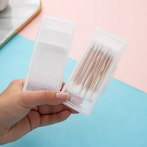 Portable cotton swab and toothpick storage boxes held in hand for size display