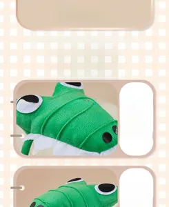 Detailed view of plush green dinosaur headband showing soft cotton filling and fine stitching