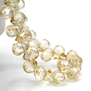 Macro view showing faceted champagne yellow K9 crystal teardrop beads with brilliant sparkle