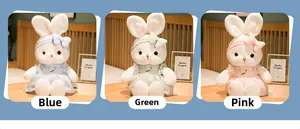 Detailed view of cute plush rabbits in blue, green and pink dresses with floral embroidery