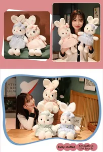 Close-up of cute plush bunny dolls in plaid dresses with fine floral embroidery details