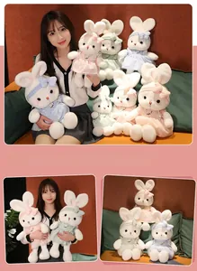 Detailed plush rabbit dolls set wearing floral lace dresses in pink blue and green tones