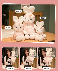 Detailed size comparison of white plush rabbit dolls in pink daisy dresses and bows