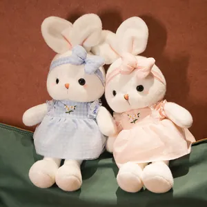 Adorable white rabbit plush pair wearing blue and pink floral dresses for kids gift