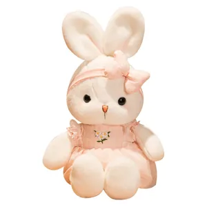 Cute white plush bunny doll wearing a pink plaid dress and daisy embroidery details