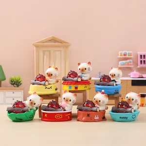 Miniature cat figurines in various poses on colorful bases for desktop decoration