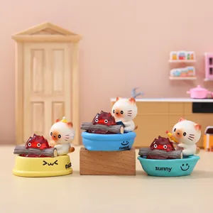 Three cute miniature cat and campfire resin figurines on colorful decorative bases