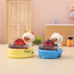 Miniature cat figurine in a sweet bathtub with a campfire decorative light ornament