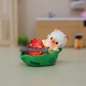 Close-up of Calcifer night light figure on green leaf base with warm glowing LED effect