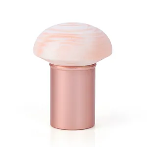Mushroom head makeup sponge with rose gold handle and unique marbled textured pattern