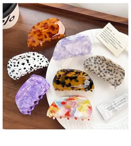 Detail view of various large acetate hair claws with diverse marble and leopard patterns