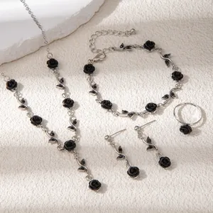 Detail view of black rose jewelry set featuring necklace, bracelet, earrings and ring