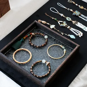 Vintage walnut wood jewelry display stand with traditional Chinese bracelets and ornaments